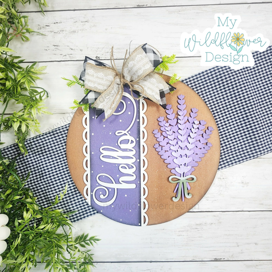Decorative sign with 'Hello' and lavender design, featuring a bow and greenery on a wooden surface.